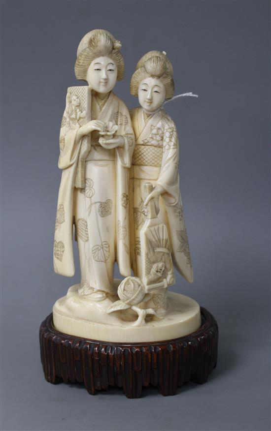 A Japanese Tokyo School carved ivory group of two geisha, late Meiji period, signed, height 18cm, overall height 21cm